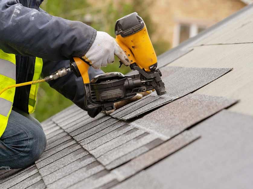 Residential Roofing 4 A Person Using A Nail Gun On A Roof